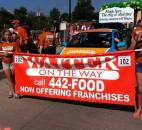 Walkers in the Fort Wayne Newspapers Three Rivers Festival Parade hold a Waiter on the Way sign. Photo submitted by Christina Newton.