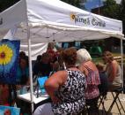 A group of people participate in a free Wine & Canvas session as part of the Art in the Park at the Three Rivers Festival in downtown Fort Wayne. (Photo by Jaclyn Goldsborough)