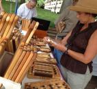 Susan Rumage, of Fort Wayne, looks at wood sealant, which is a protective polish for the handmade wood kitchen utensils at the Kitchenware by Dickinson Furniture booth at the Arts in the Park at Freimann Square as part of the Three Rivers Festival. (Photo by Jaclyn Goldsborough)