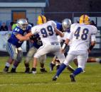 Homestead’s Zach Swarts was called for a facemask penalty against Carroll’s Chris Terry on the first play from scrimmage Friday. (By Blake Sebring of The News-Sentinel)