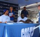 Offensive tackle Anthony Castonzo and guard Donald Thomas signed posters and T-shirts for fans Friday. Nicole Wilson of Fort Wayne was first in line to meet the players at the Colts Fan Fest at the Fort Wayne Newspapers Three Rivers Festival. (Photo by Jaclyn Goldsborough of The News-Sentinel)