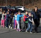 Connecticut State Police lead a line of children from the Sandy Hook Elementary School in Newtown, Conn., on Dec. 14. A gunman opened fire at the elementary school, killing 20 children and six adults before turning the gun on himself. It was one of the worst mass killings in the nation's history. Photo by The Associated Press
