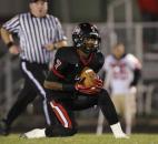 Bishop Luers’ Michael Rogers barely avoids touching his knee while catching a North Side punt before returning it for a touchdown in Bishop Luers’ 22-20 win over the Redskins on Friday at Luersfield. (By Chad Ryan of INMedia Source)