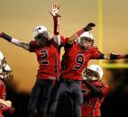 Heritage defensive backs Zach Toles, center left, and Cole Gerardot, center right, celebrate after Toles intercepted a Garrett pass in the first quarter of the Patriots' 56-2" win on Friday at Heritage. Photo by Chad Ryan