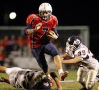 Heritage running back Will Knapke, center, leaps over Garrett's Brett Schendel, left, and Austin McCray for a big gain in the first half of the PAtriots' 56-2" ACAC win on Friday at Heritage. Photo by Chad Ryan