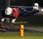 Heritage running back Brenton Lockett dives for the pylon at the Garrett goal line for a touchdown in the Patriots' 56-2" win on Friday at Heritage. Lockett's touchdown was called back on a Heritage penalty, but the Patriots scored a few plays later to push their lead to 49-"4 at that point in the game. Photo by Chad Ryan