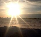 The sun sets over the wintry landscape of a cornfield off West Hamilton Road on Tuesday. Plenty of sun and rising temperatures this week will help do away with much of the piled snow across the area. (Photo by Dan Vance of The News-Sentinel)