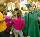 Bishop John D'Arcy, right, greets one of the migrant families at the conclusion of a Mass in September 2009 at St. Joseph Catholic Church in Bluffton. News-Sentinel file photo