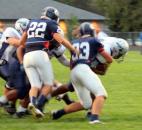 Garrett’s Bo Davis wraps up a Woodlan runner on Friday at Garrett. Garrett’s Brett Schendel is at left ready to help. Garrett won 30-26. (By Don Converset of The News-Sentinel)