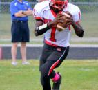 North Side quarterback C.J. Jackson rolls out looking for an opening receiver during the first quarter Friday night against Bishop Dwenger. (Photo by Blake Sebring of The News-Sentinel)