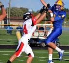 Homestead quarterback Matt Skowronektries to get a pass off against the defense of Huntington North’s Nathan Sutter during the first quarter Friday night. (By Blake Sebring of The News-Sentinel)