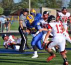 Homestead senior Grayson Bastin runs up the middle against Huntington North’s defense in the first quarter Friday night. (By Blake Sebring of The News-Sentinel)