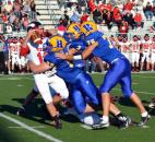 Huntington North quarterback Drew Schnitz gets buried by the defensive line of Homestead led by the Spartans’ Zach Swarts, No. 99. (By Blake Sebring of The News-Sentinel)