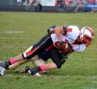 North Side receiver Zack McKinstry catches a pass along the sideline as Bishop Dwenger’s Gerald McGee makes the tackle. (Photo by Blake Sebring of The News-Sentinel)