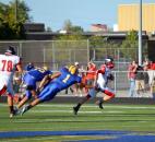 Homestead defensive lineman Elijah Zavala drives but just missed tackling Huntington North quarterback Drew Schnitz during the first quarter Friday night. (By Blake Sebring of The News-Sentinel)