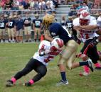 North Side’s Latavion Guy makes the tackle against Bishop Dwenger quarterback Cody Miller during a first-quarter scramble. (Photo by Blake Sebring of The News-Sentinel)