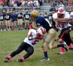 North Side’s Latavion Guy makes the tackle against Bishop Dwenger quarterback Cody Miller during a first-quarter scramble. (Photo by Blake Sebring of The News-Sentinel)