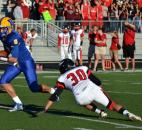 Homestead quarterback Matt Skowronek is about to be tackled by Huntington North’s Skyler Veilleux during the first quarter Friday night. (By Blake Sebring of The News-Sentinel)