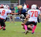 Bishop Dwenger receiver Ryan Watercutter is stripped from behind as North Side defenders Zach McKinstry and Dustin Gregory close in. (Photo by Blake Sebring of The News-Sentinel)