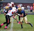 North Side’s Demond Gaston lines up Bishop Dwenger running back D’Marcus Moon for a loss. (Photo by Blake Sebring of The News-Sentinel)