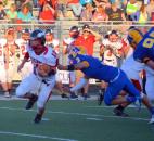 Huntington North quarterback Drew Schnitz tries to avoid the tackle of Homestead’s Alex Etchison during the second quarter Friday night. (By Blake Sebring of The News-Sentinel)