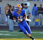 Homestead receiver Isaac Griffith looks to throw off a reverse late in the second quarter Friday night. (By Blake Sebring of The News-Sentinel)