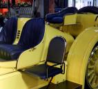 The side seat on this 1911 Oldsmobile Autocrat Race Car may look like a "mother-in-law seat," however, a worker said it was where the mechanic would sit. A Maryland man who owned the vehicle from 1911 until his death in 1968 modified the body and raced in it.