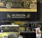 A woman walks near a Hudson ad.