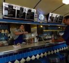 A George & Sally’s Blue Moon Diner employee serves a worker lunch.