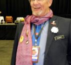 Fred Gilbert, who works with local Burmese, wears a number of Aung San Suu Kyi-related items, including an artificial flower with the phrase in Burmese, “Be brave.” “That’s Suu Kyi’s phrase,” he said. By Lisa Esquivel Long 