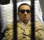 Egypt's ex-President Hosni Mubarak lays on a gurney inside a barred cage at the police academy courthouse in Cairo, Egypt. Mubarak was sentenced in June to life in prison for his role in the killing of protesters during last year's revolution that forced him from power after nearly three decades. Photo by The Associated Press