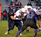 Heritage senior quarterback Conner Sheehan gets wrapped up by Leo junior defensive lineman Logan Glaze. (By Blake Sebring of The News-Sentinel)