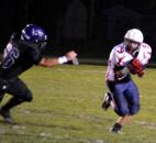 Heritage junior Cole Gerardot looks for running room against Leo senior Jeremy Gladieux on a punt return. (By Blake Sebring of The News-Sentinel)