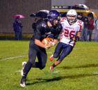 Leo sophomore running back Logan Leiter charges upfield as Heritage’s C.J. Whitman runs in to make the tackle. (By Blake Sebring of The News-Sentinel)
