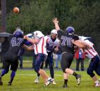 Heritage quarterback Conner Sheehan unloads despite the rush of Leo’s Nolan Wilson, No. 47, and junior Bryce Hager, No. 70. (By Blake Sebring of The News-Sentinel)