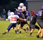 Heritage’s Duncan York, with help from teammate Jacob Roop above, tackles Leo quarterback Sam Waters. (By Blake Sebring of The News-Sentinel)