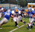 Carroll’s Jimmy Crumley makes use of a great block by teammate Taylor Goshen on Homestead’s Caleb Hackley to run for more yards outside during the first quarter Friday night. (By Blake Sebring of The News-Sentinel)