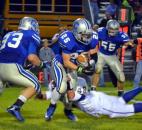 Homestead’s Wyatt Butcher drives into the feet of Carroll’s Jimmy Crumley to make a tackle during the second quarter Friday night. (By Blake Sebring of The News-Sentinel)