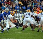 Homestead quarterback Matt Skowronek looks for an inside lane against Carroll’s defense Friday night. (By Blake Sebring of The News-Sentinel)