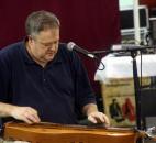 Richard Ash plays his version of Michael Jackson’s "Beat It" on his dulcimer at the Allen County Fair Wednesday. Ash owns Folkcraft Instruments in Woodburn.(Photo by Wes Young of The News-Sentinel)