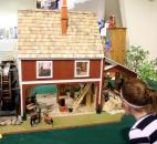 Paige Wooldridge, 9, takes a closer look at a model barn at the Allen County Fair. (Photo by Wes Young of The News-Sentinel)