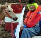 The rodeo clown and his miniature horse wait for the rodeo to start during the opening ceremony on Tuesday night at the Allen County Fair. (Photo by Hana Hawash of The News-Sentinel)