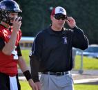 Bishop Luers interim coach Kyle Lindsay works with quarterback Noah Wezensky during pregame warm-ups Friday night. (By Blake Sebring of The News-Sentinel)