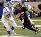 Quarterback Quinn Schafer scrambles away from Heritage Christian defenders during Bishop Luers' 21-6 win in the 2007 Class 2A state finals at the RCA Dome in Indianapolis. Schafer threw a 71-yard touchdown pass in the second half to put the Knights in the lead. With this victory, Bishop Luers became the second team in IHSAA history to have four or more regular season losses and still win the Class 2A state championship. (File photo by Ellie Bogue of The News-Sentinel)