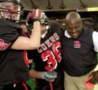 Bishop Luers players Pat Wyss and Jhormy Martinez and assistant coach Derrick Dennis celebrate their 57-26 victory against Evansville Mater Dei in the 2001 Class 2A state finals at the RCA Dome in Indianapolis. This championship-game rematch came one year after Evansville beat Bishop Luers 56-10 in the 2000 state finals. Bishop Luers' 57 points remains the third-most points scored in a Class 2A state finals game. (News-Sentinel file photo)