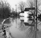 Water from the St. Marys River flows over sandbags at the corner of Camp Allen Drive and Elm Street in Fort Wayne's Nebraska neighborhood.