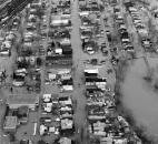 An aerial view shows the St. Marys River overflowing Camp Allen Drive in the West Main Street area on March 14. West Main Street runs vertically through the photo, heading downtown at the top.