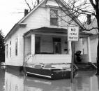 A boat is tied to the front porch of a flooded house in the West Main Street area.