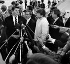 Fort Wayne Mayor Win Moses Jr., in the light-colored jacket in the center, repeatedly appeared on television to tell of the urgent need for volunteers. Later in the week, President Reagan, shown here surrounded by Secret Service agents, told a crowd at Baer Field "how much their neighbors in the country feel for them and how concerned we are."