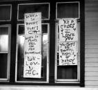 JoAnn Chalmers' posters praise God, the Red Cross, firefighters and the police at her home at 1306 W. Main St. The cars in front of her home were submerged nearly to the roofline, and the apartment below hers was badly flooded.